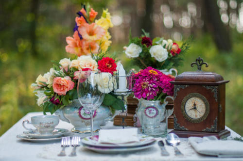 Beautiful bouquet of roses with the table set in the wood