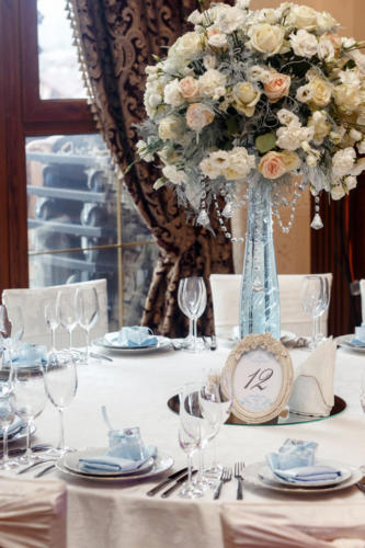 luxury wedding decor with flowers and glass vases and number of
